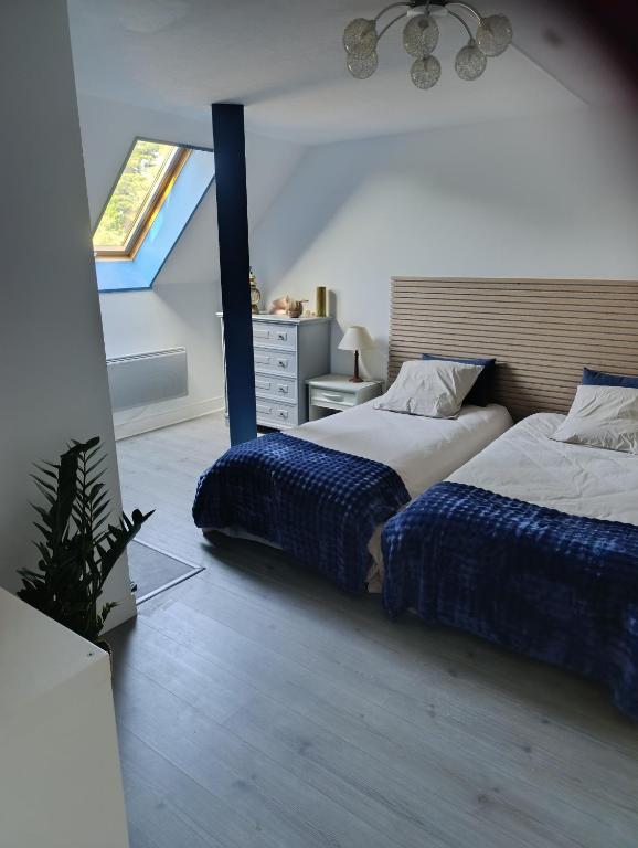 a bedroom with two beds and a window at Trégouet 8 - Chambre 3 in Saint-Nazaire