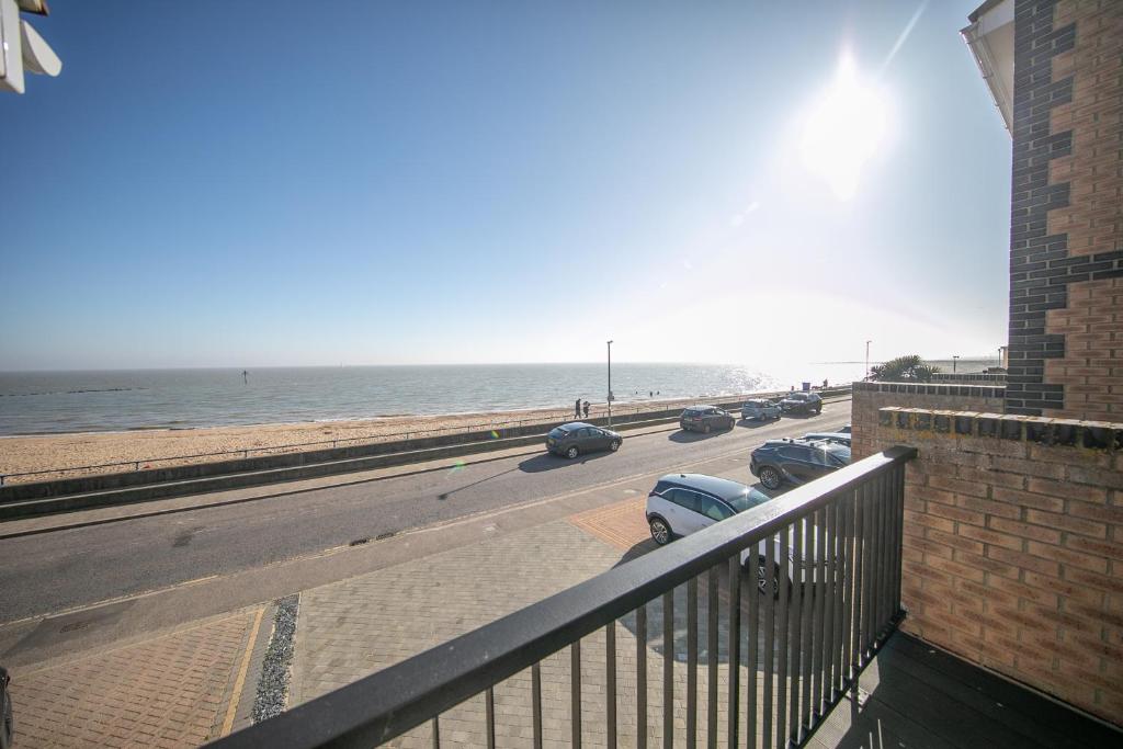 a view of a road with cars parked on the beach at Seaview in Clacton-on-Sea