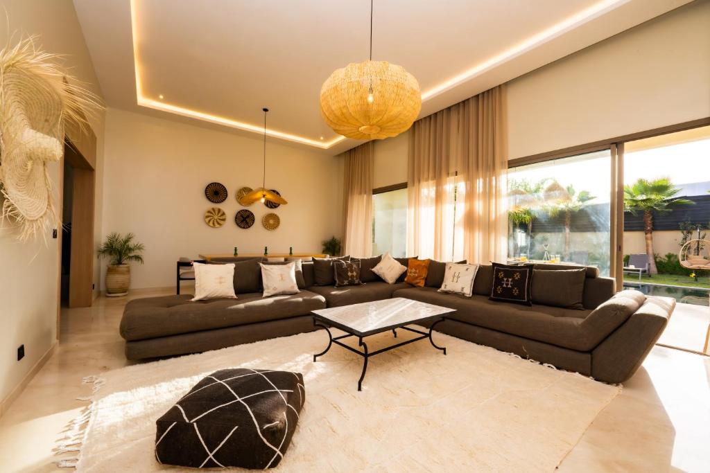 a living room with a couch and a table at Luxurious Marrakech Villa Pool, Hammam,Cinema in Marrakesh