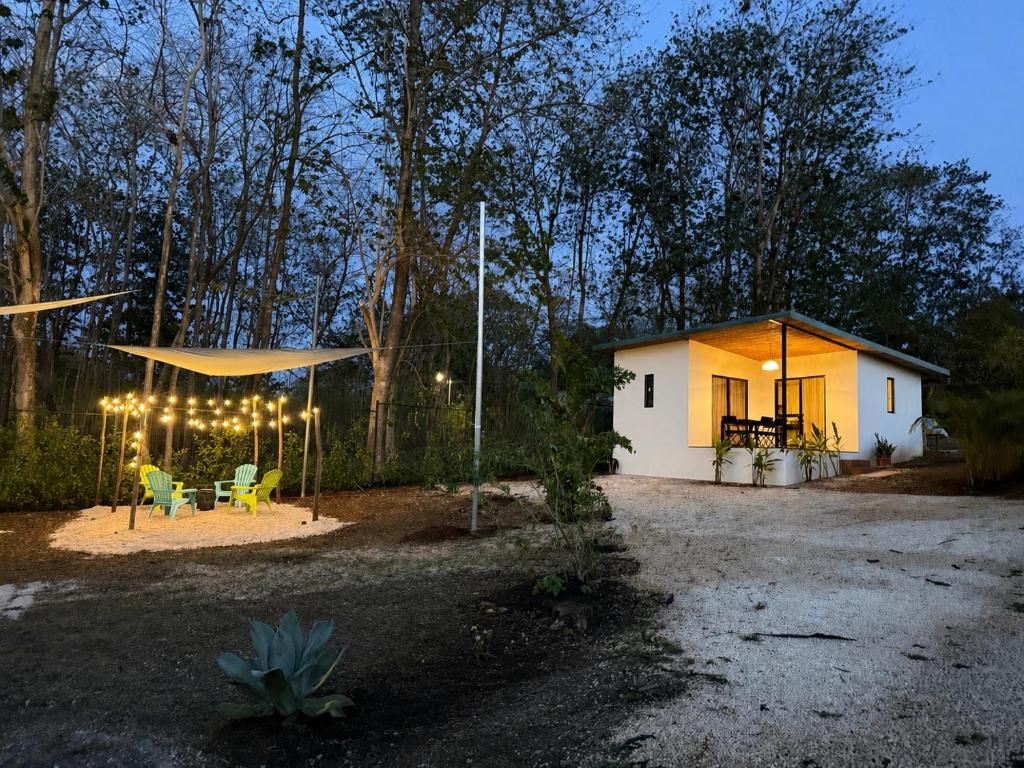 a small house with lights on the side of it at Avellanas Tiny Villa 1BR Private Self check in in Santa Cruz