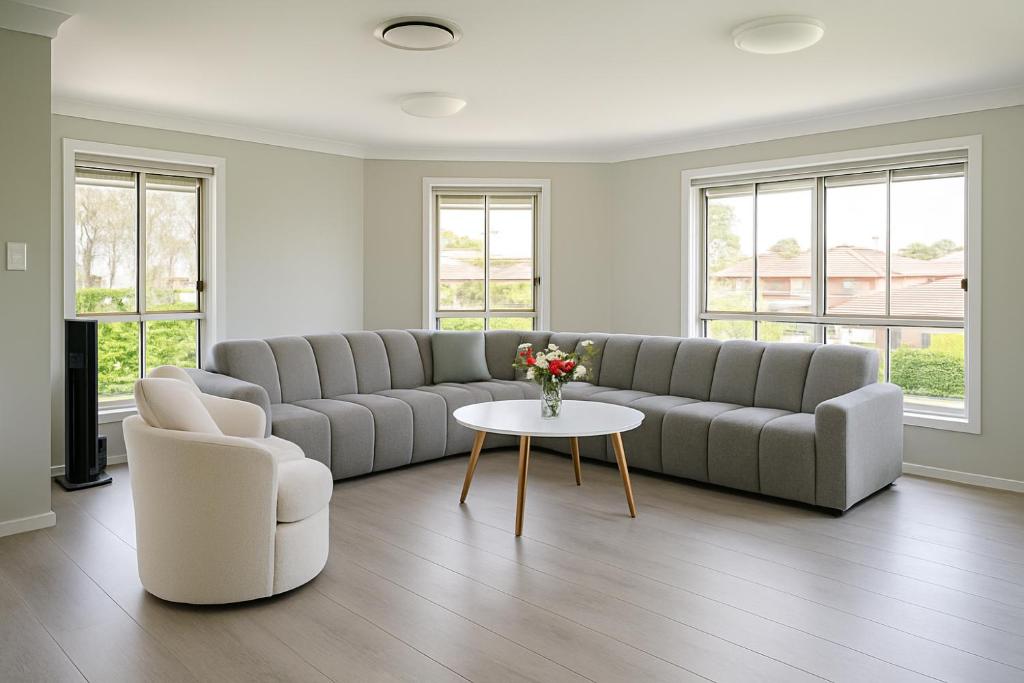 a living room with a couch and a table at Emmaus Hill in Blue Haven