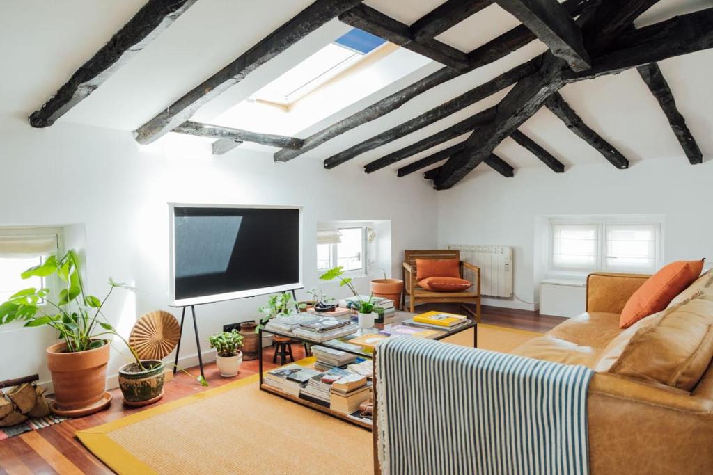 a living room with a couch and a flat screen tv at GOZATEGI - Photo studio in Irún