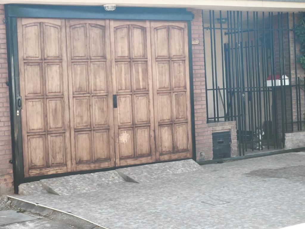 a pair of wooden doors on a building at Pausa viajera in Las Heras