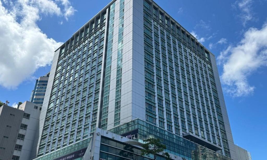 a tall building with glass windows on the side of it at Centum City Hotel in Busan