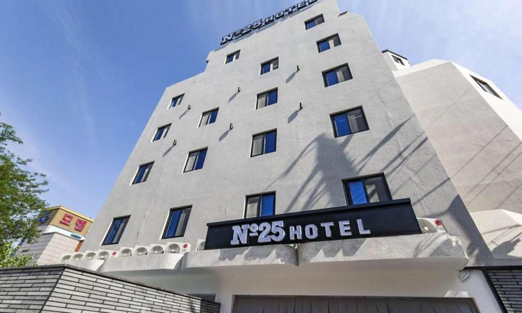 a building with a hotel sign in front of it at JECHEON No 25 HOTEL in Jecheon