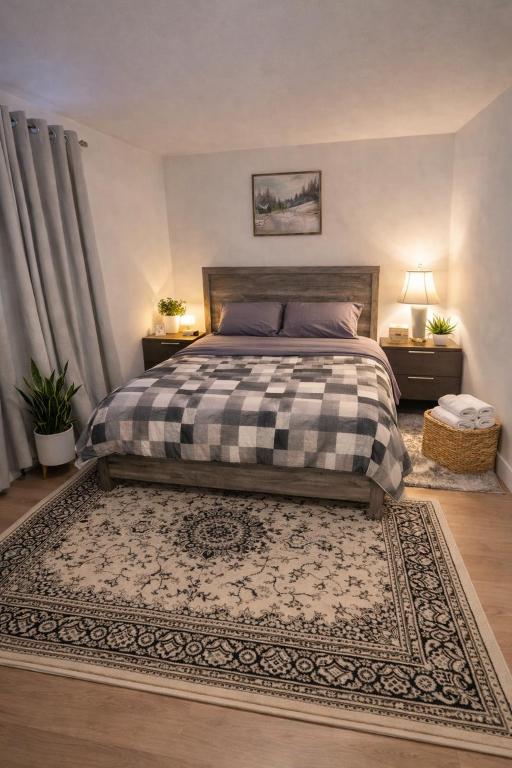 a bedroom with a bed and two night stands and a rug at Moonlight Suite in Riverview