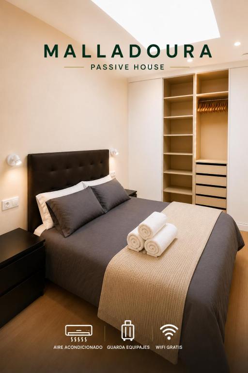 a bedroom with a bed with two towels on it at Malladoura Passive House in Porriño