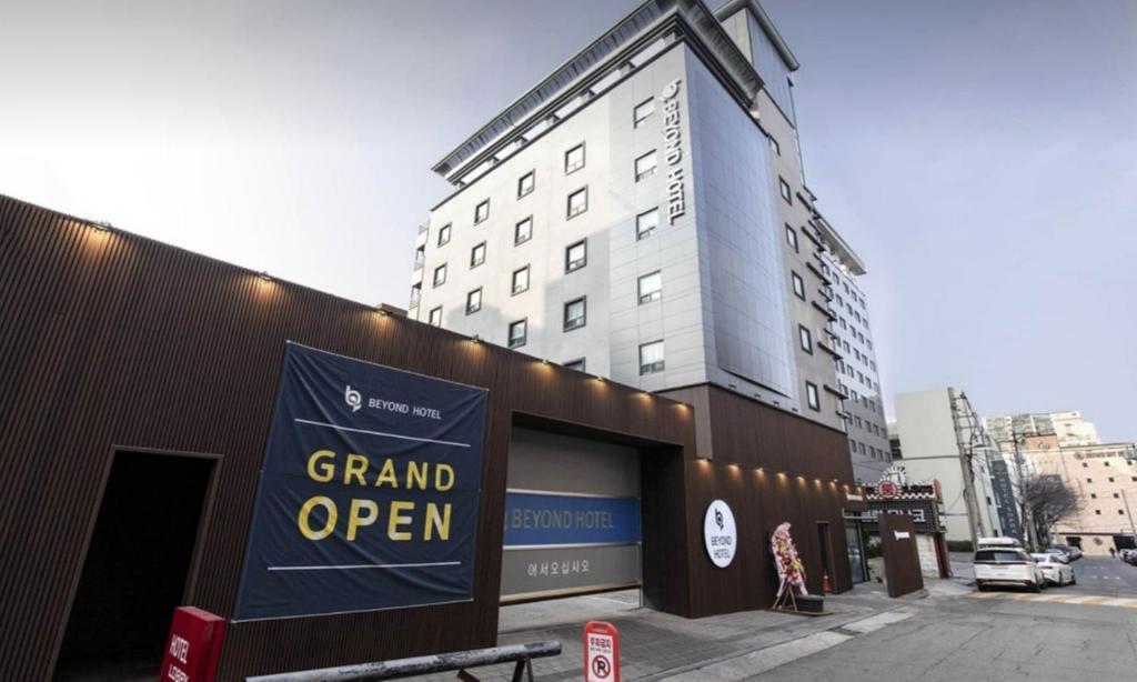 a grand open sign on the side of a building at Beyond Hotel in Incheon