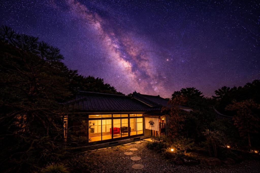 a house at night with the milky way at IPPONMATSU Private Villa - 宮崎の古民家一棟貸し 一本松 in Miyazaki