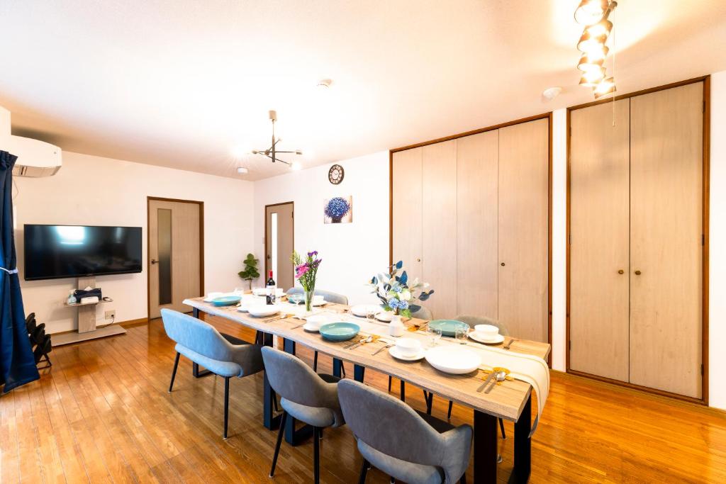 a large dining room with a long table and chairs at kagoshima take in Kagoshima