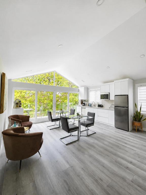 a large white living room with tables and chairs at Luxury Nest B&B in Niagara-on-the-Lake
