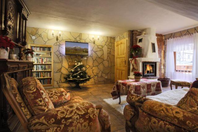 a living room with a christmas tree in the corner at Apartmány ReMi Vysoké Tatry in Smokovce