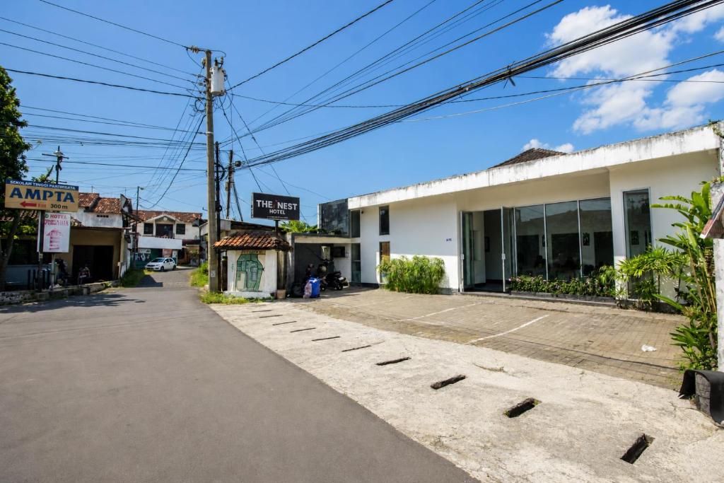 an empty street in front of a building at Nest Hotel Jogja in Seturan