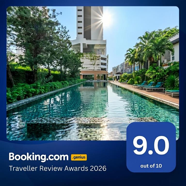 a view of a swimming pool in front of a building at Veranda Residence Pattaya in Na Jomtien