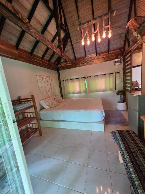 a bedroom with a bed and a wooden ceiling at nam jai pai in Ban Wiang Nua