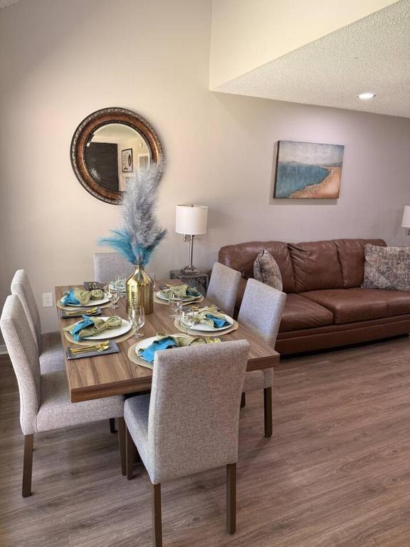 a living room with a table and a couch at 2 King Suites w/ Private Baths + Workspaces | LSU in Baton Rouge