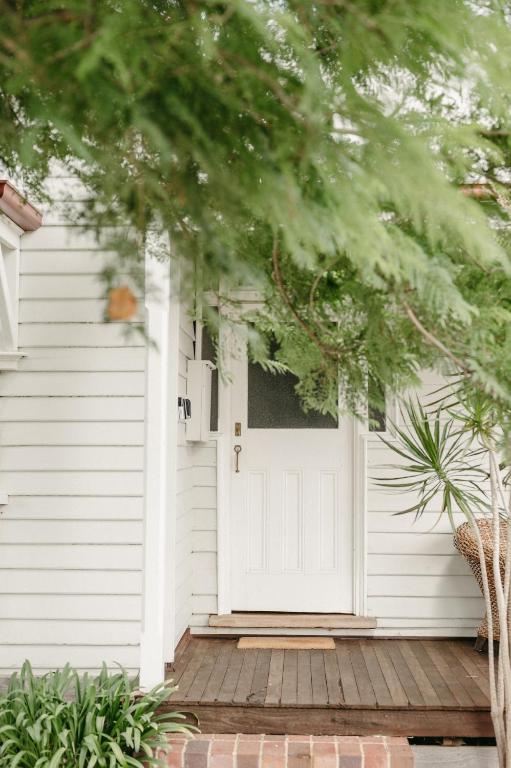 a white door on a house with a porch at Heritage Hideaway in Bunbury