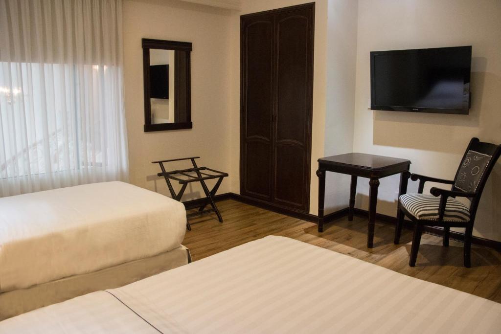 Postel nebo postele na pokoji v ubytování Hotel Castilla Real