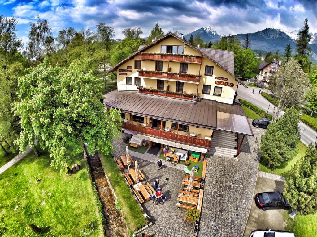 an overhead view of a large building with a tree at Penzión Slalom in Vysoké Tatry