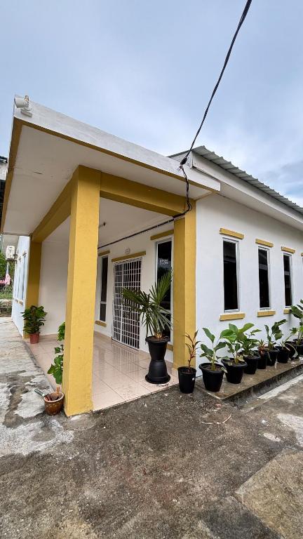 a building with potted plants in front of it at Ayem Resort Langkawi in Air Hangat