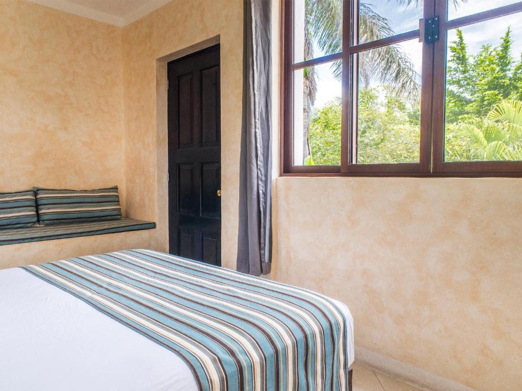 Postel nebo postele na pokoji v ubytování Hotel Barrio Latino
