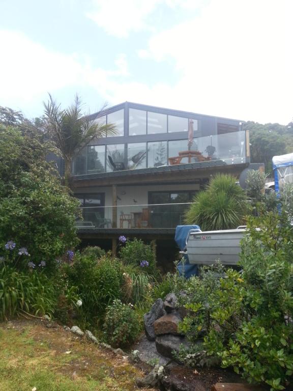 a house with a view of a garden at Bay View Retreat Apartment in Whangarei Heads