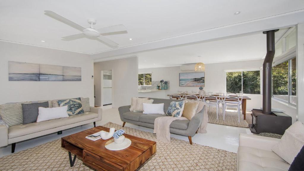 a living room with a couch and a table at Pool, Pet - Friendly, Fireplace, Walk To Beach in Pearl Beach