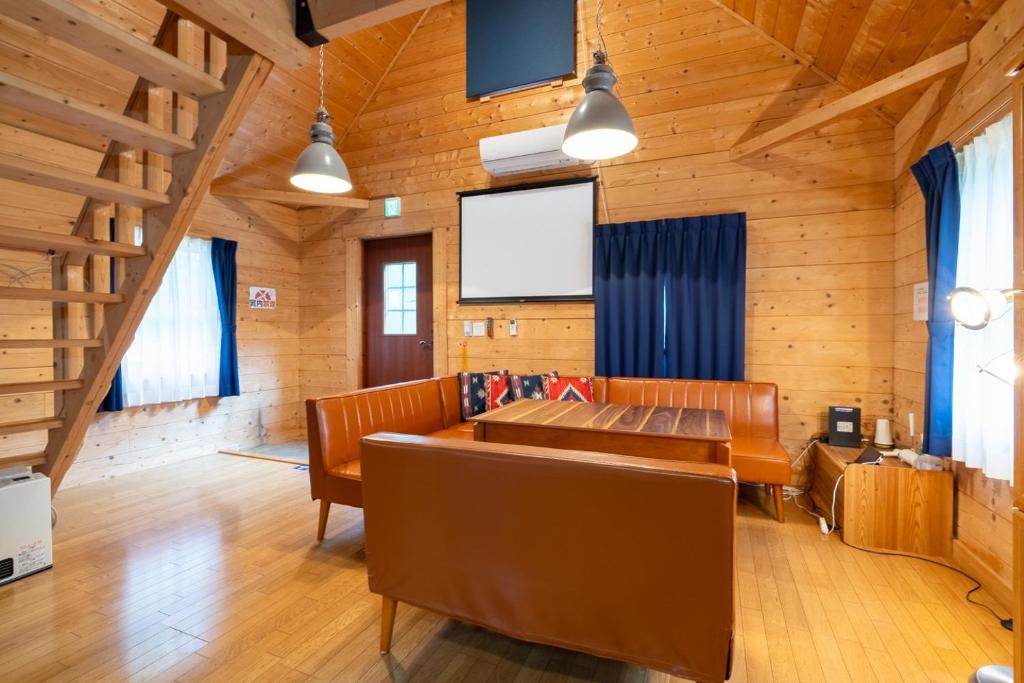 a living room with a couch and a tv at S-villa Nasu 12th in Nasu-yumoto