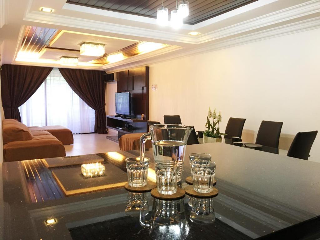 a living room with a table with glasses on it at Putra Villa Short Stay Apartment KL in Kuala Lumpur