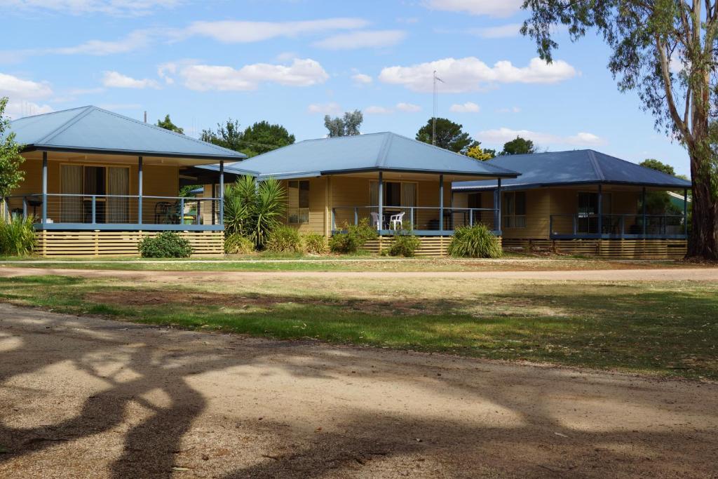 two houses with blue roofs in a park at Tooleybuc River Retreat Villas in Tooleybuc