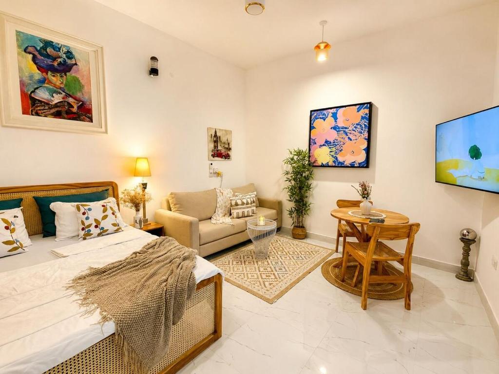 a bedroom with a bed and a living room at Kai Apartments Near Airport Zanzibar in Zanzibar City