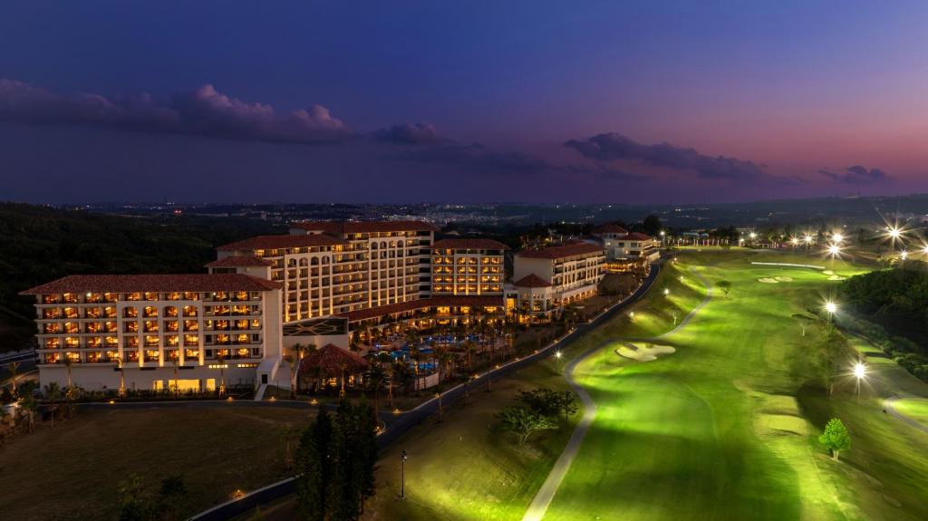 a city lit up at night with buildings and street lights at PGM Hotel Resort Okinawa in Onna