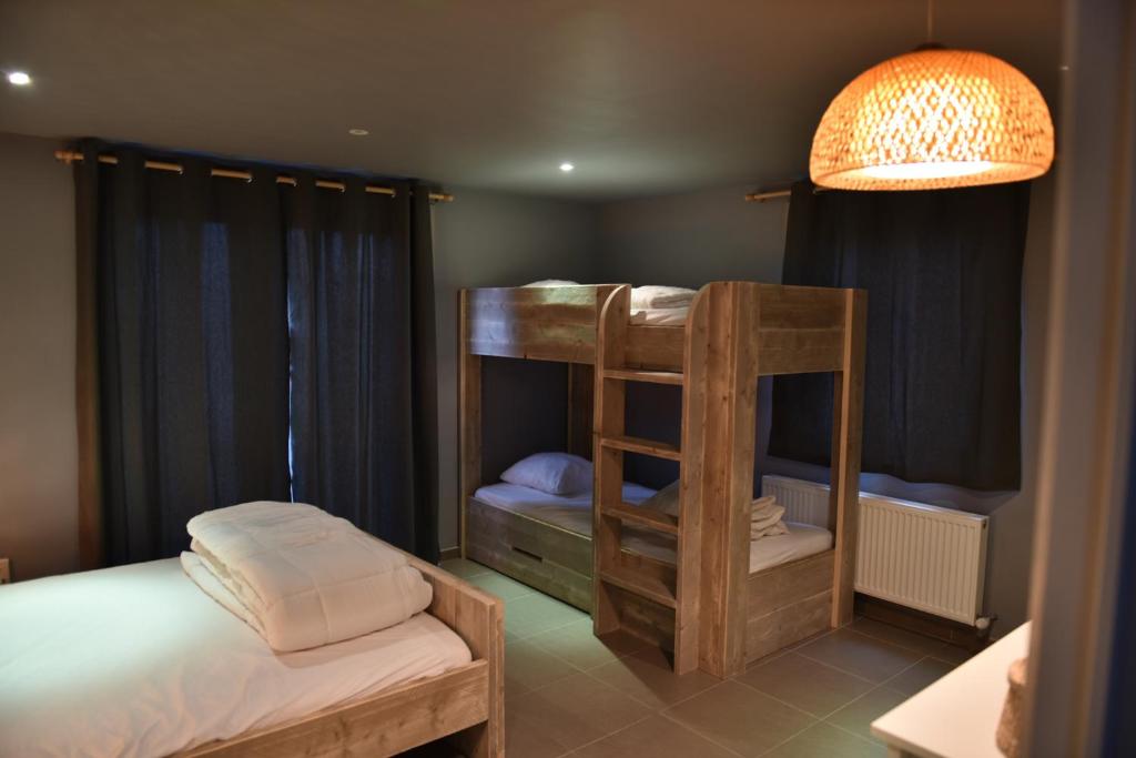 a bedroom with a bunk bed and a lamp at Hof Ter Meulen in De Haan