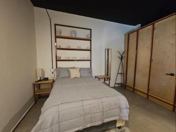 a bedroom with a large bed in a room at Casa Tabacalera in Mexico City