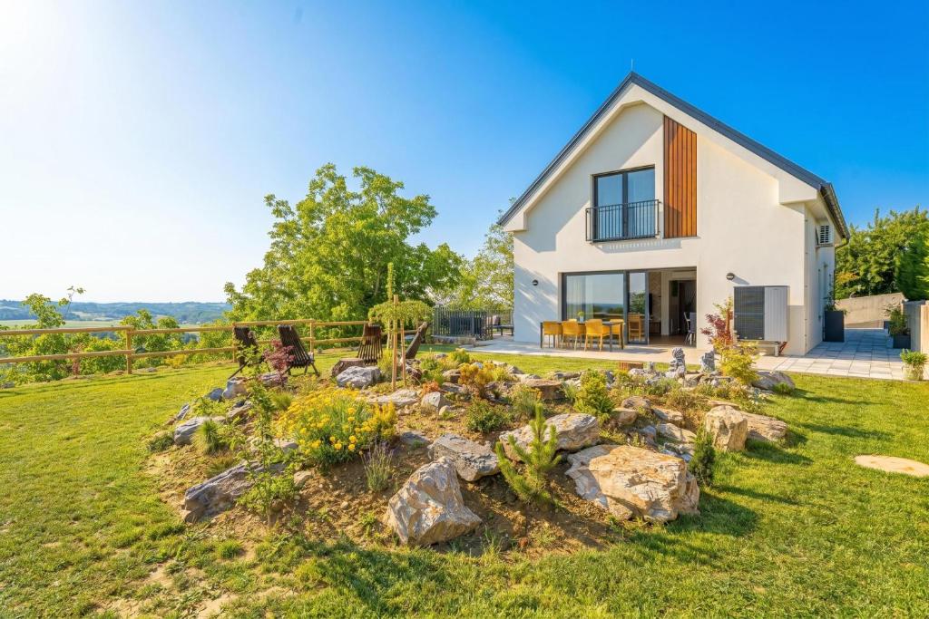 a house with a garden in front of it at Villa Vinita w/ Jacuzzi & Sauna near Thermal Spa - Happy Rentals in Sveti Jurij ob Ščavnici