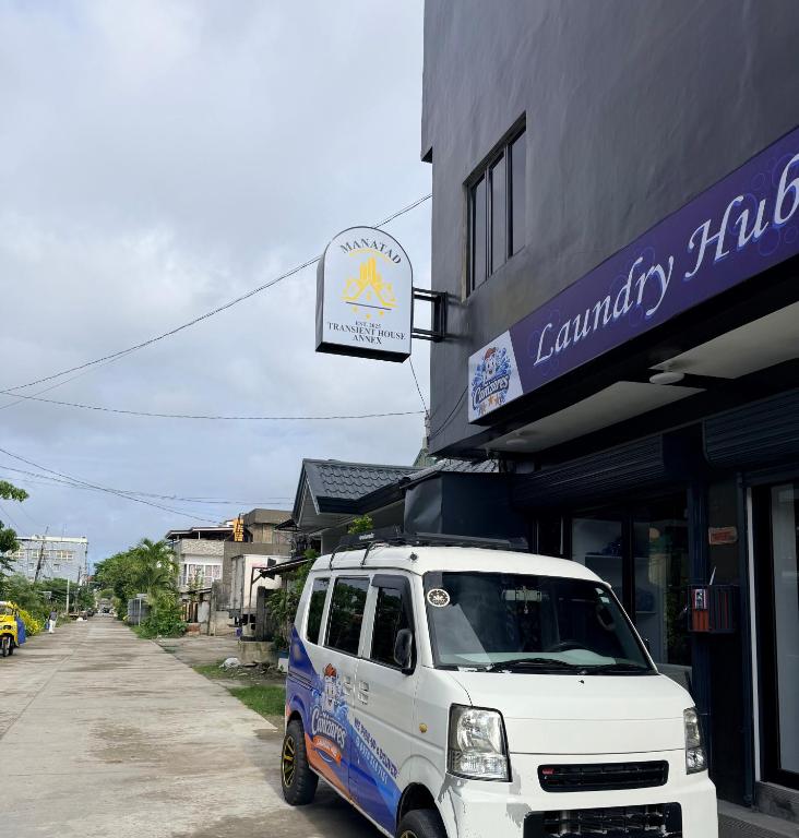 a white van parked in front of a building at Manatad Transient Deluxe Room 2 in Surigao