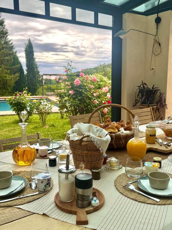 a table with a basket of food and a view at La Cadole de Chardonnay in Chardonnay