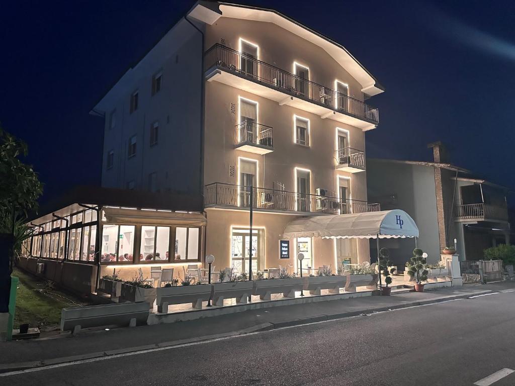 a large white building with an umbrella in front of it at Terme Palace Hotel in Montecatini Terme