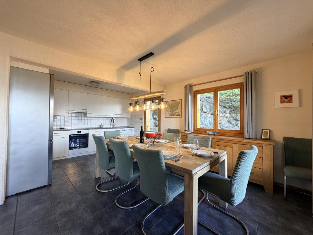 a kitchen and dining room with a table and chairs at Mont Bijou MOUNTAIN & QUIET chalet 10 pers by Alpvision Résidences in Veysonnaz