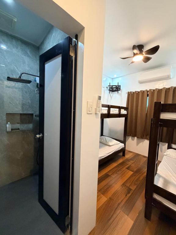 a bathroom with a mirror and a bunk bed at Manatad Transient Family -2 in Surigao