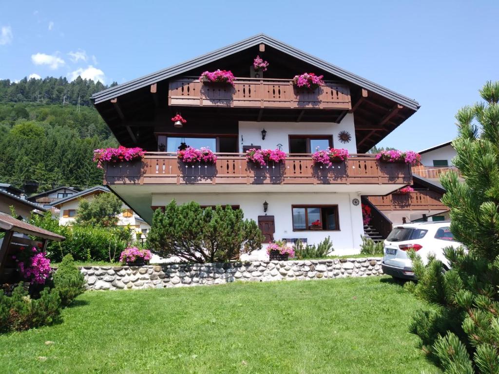 a house with flower boxes on the balcony at Casa Lassù in Pieve di Cadore