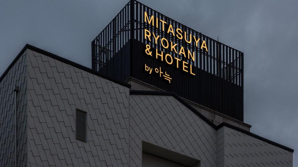 a building with a sign on the top of it at Mitasuya Ryokan Hotel by Anook Gwangju in Gwangju