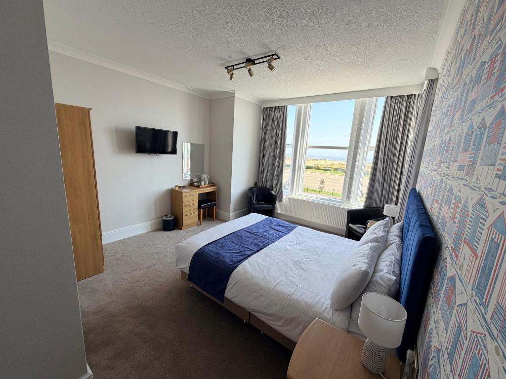 a hotel room with a bed and a window at Imperial Lodge in Great Yarmouth
