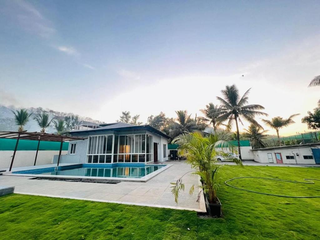 a house with a swimming pool in a yard at shreeraj farms in Kolshet