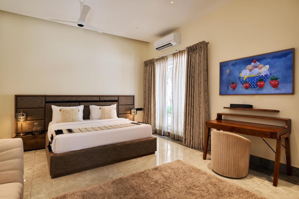 a bedroom with a bed and a piano at Villa Raag in Agonda