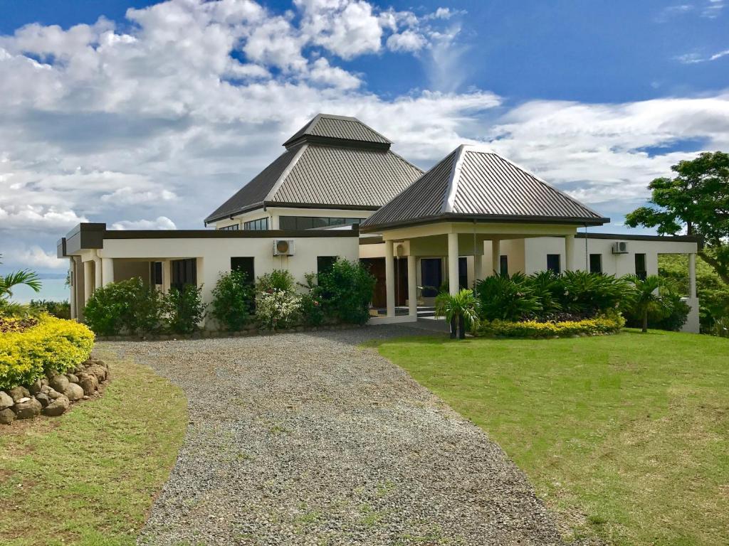 a large white house with a roof at Sapphire Bay Fiji in Viseisei