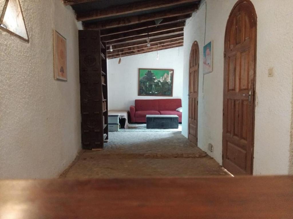 a hallway with a red couch in a room at Nougouranch in Rufisque