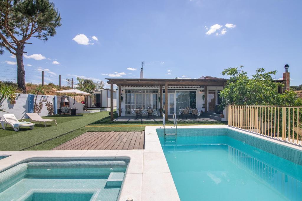a swimming pool in front of a house at El Encanto in Villarrasa