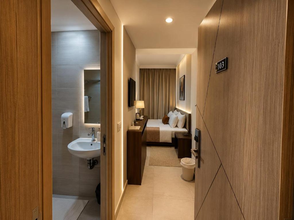 a bathroom with a sink and a toilet and a bed at new Villa117 in Cairo