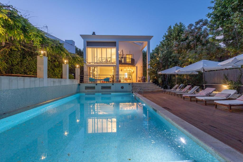 a house with a swimming pool in front of a house at Villa Cela in El Masnou